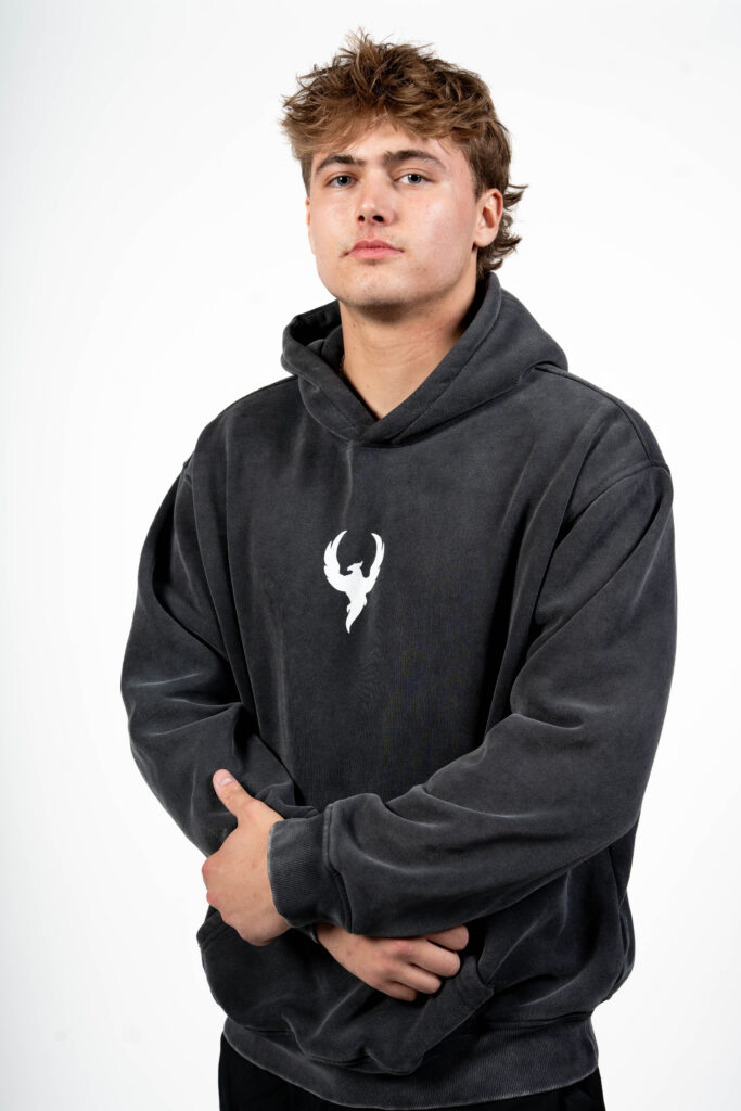 Man wearing Reborn Hoodie in studio